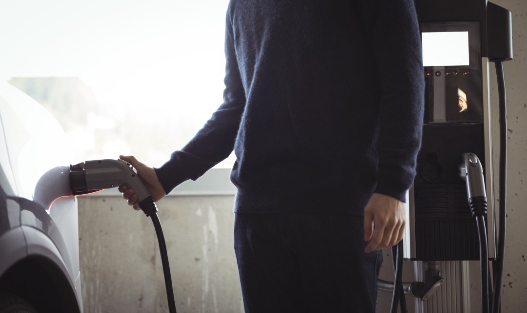 man-charging-car-electric-vehicle-charging-station-1